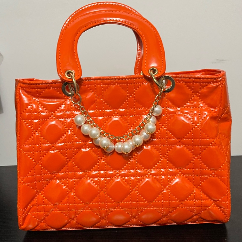 Orange bubble quilted pattern purse with pearl chain link